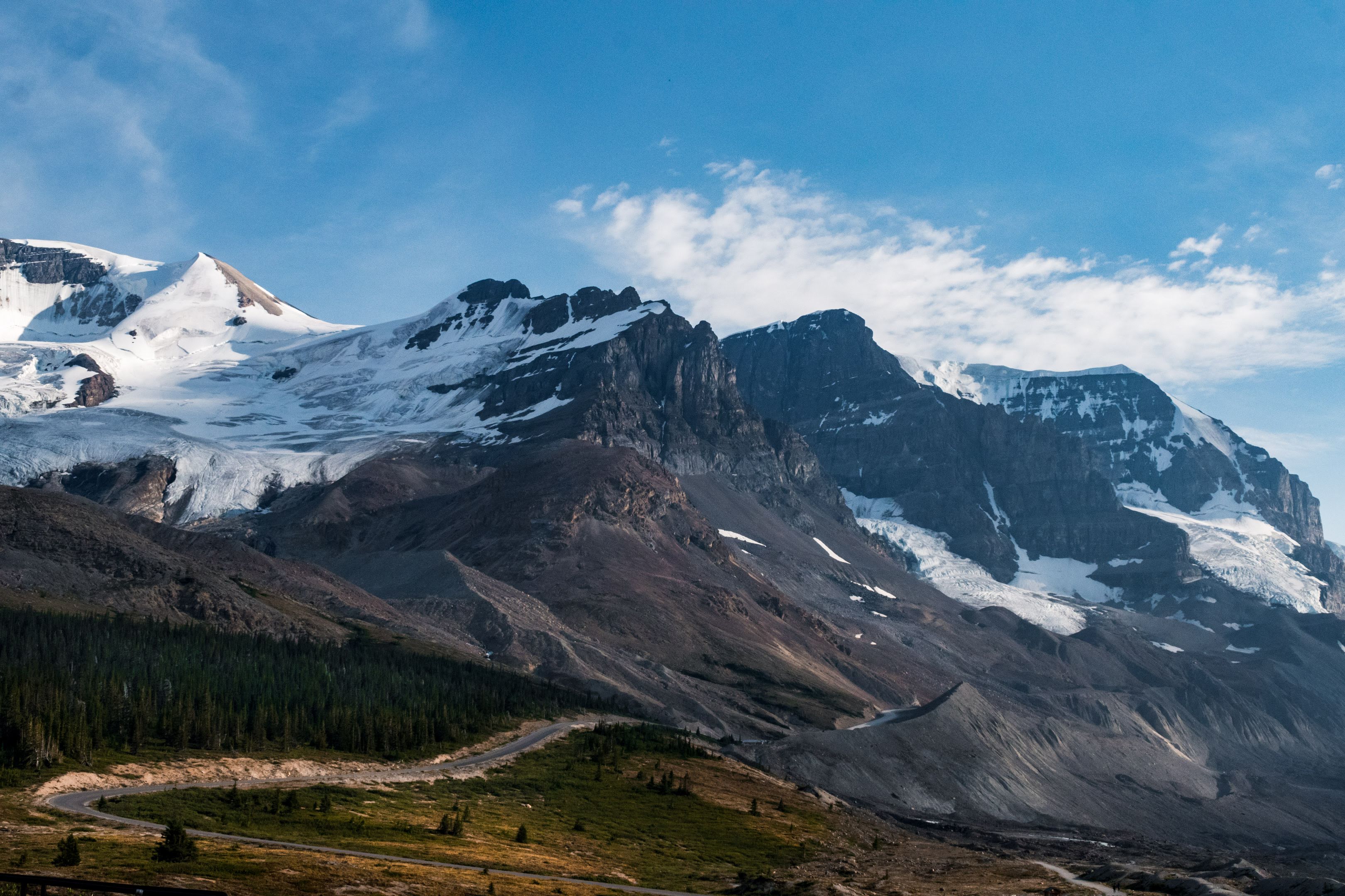 Mountain peaks beneath a wide blue sky